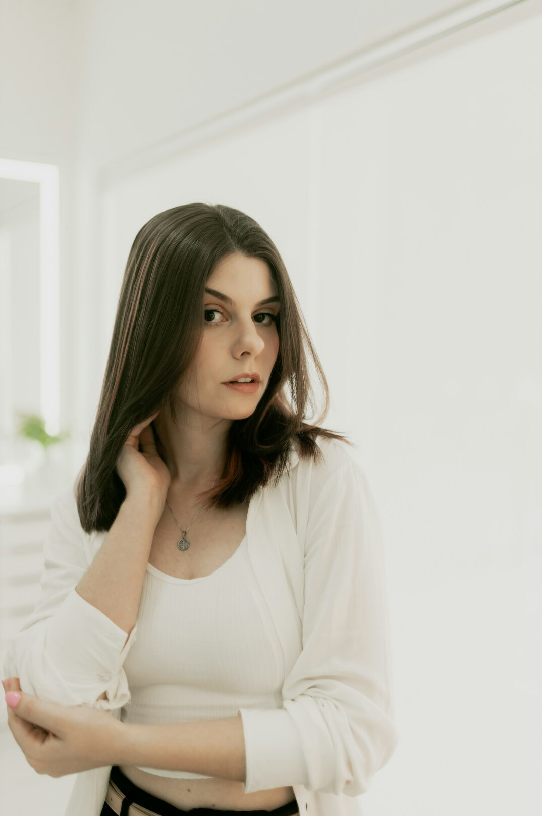 Portrait of a professional woman with dark hair in a bright office