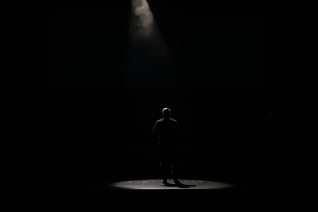 Empty theatre stage with spotlight and curtains